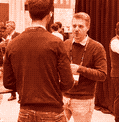 Two of the team talking at a conference